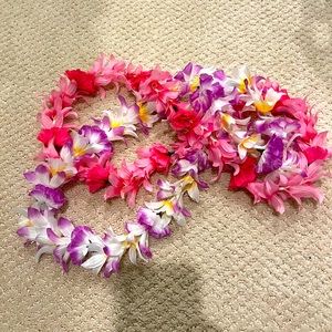 2 leis. One pink. Other purple.